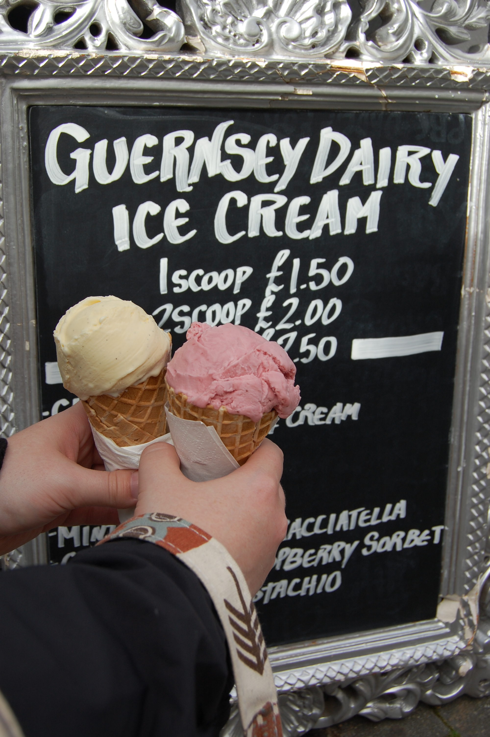literary travel, Guernsey ice cream, ice cream in front of sign, Guernsey cow